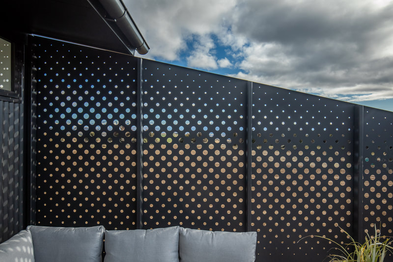 Steel privacy screen with cut out circles detailing